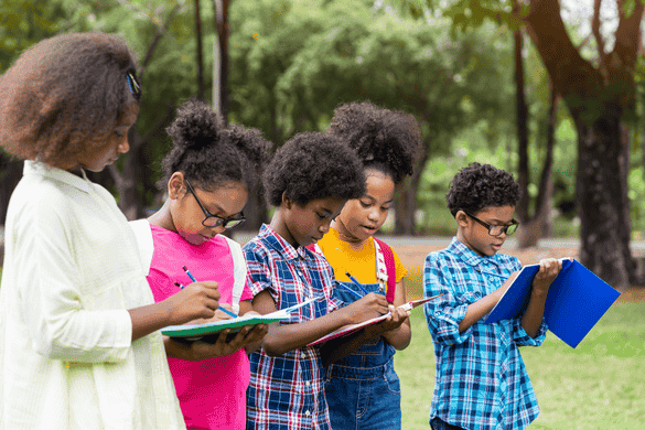 students taking notes while outside on a field trip